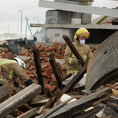 First responders searching at a mass fatality incident site.